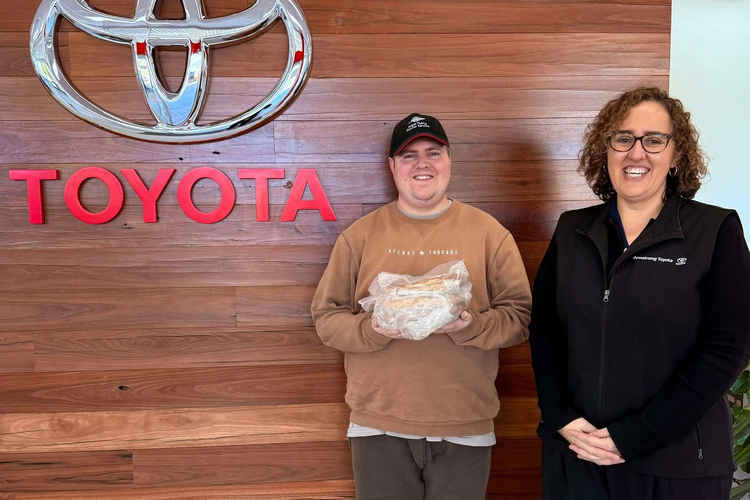 SUPPORTIVE: Ollie MacFarlane with Barb Last of Armstrong Toyota on his volunteer rounds. Photo supplied.